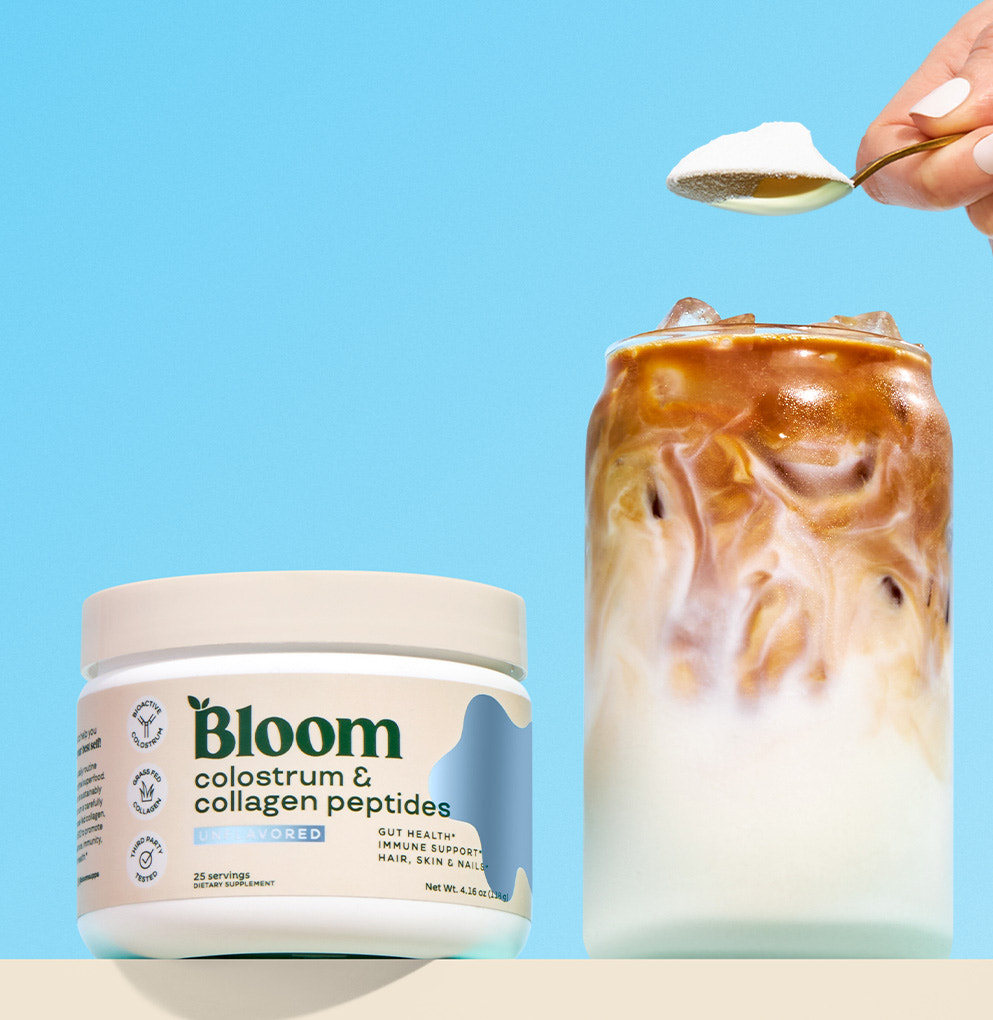 Bloom Colostrum & Collagen Peptides with spoon and iced coffee swirl on blue background
