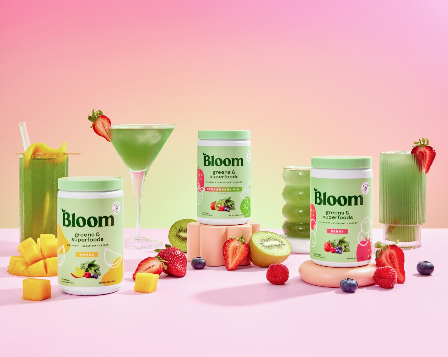 Bloom Greens & Superfoods in Mango, Strawberry Kiwi, and Berry flavors with vibrant green drinks and fresh fruit
